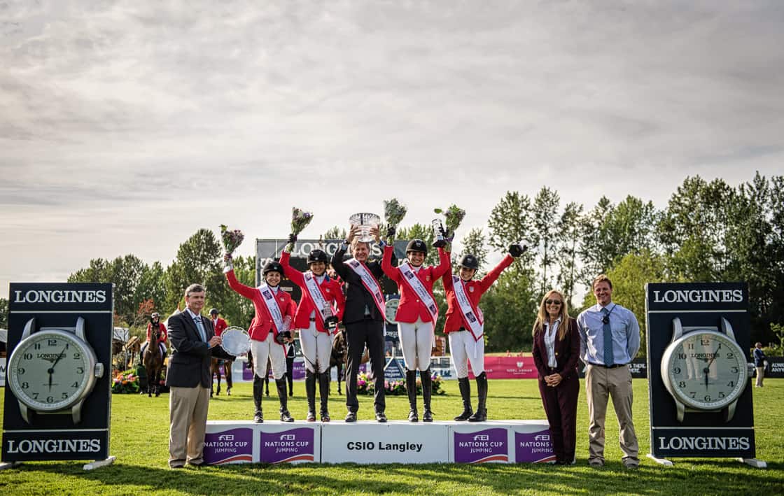 The Hermès U.S. Show Jumping Team stands atop the podium with Chef d’Equipe Robert Ridland to receive the top honors in the FEI Nations Cup™ CSIO4* Langley ©MOIPhotography / Aimee Wilson for Thunderbird Show Park