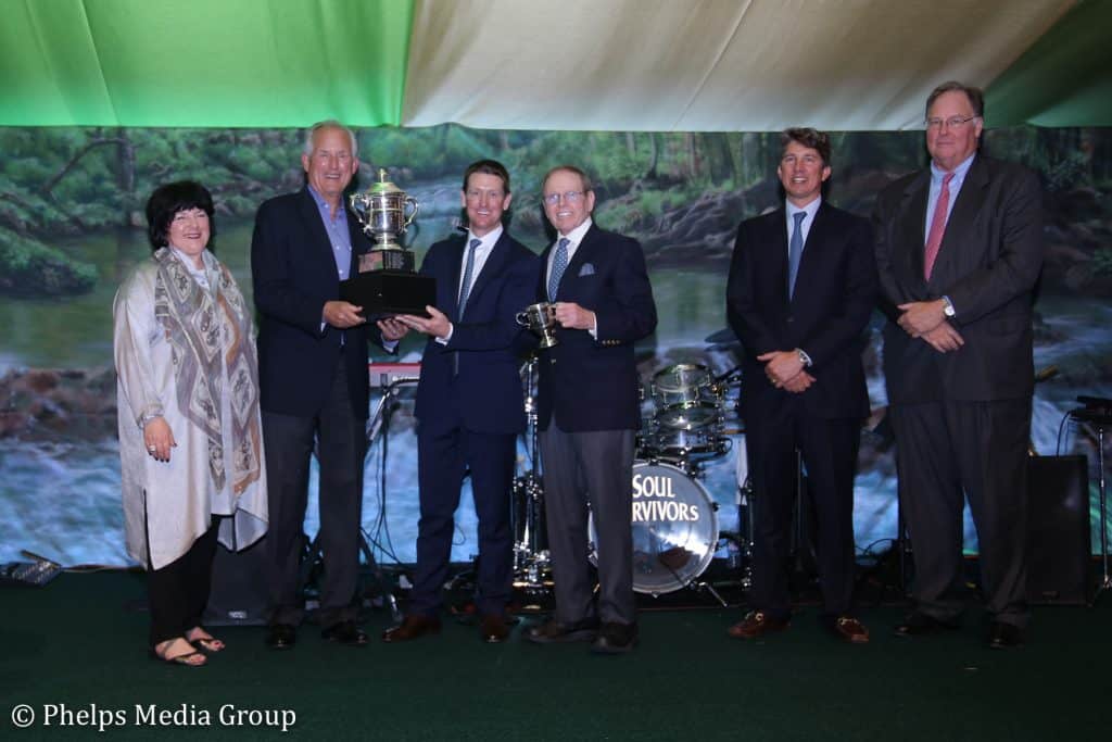 Left to right: Betsy Juliano, Jim McNerney, McLain Ward, Brownlee O. Currey, Jr., Philip Richter and William Weeks present Ward with the 2018 Whitney Stone Cup.
