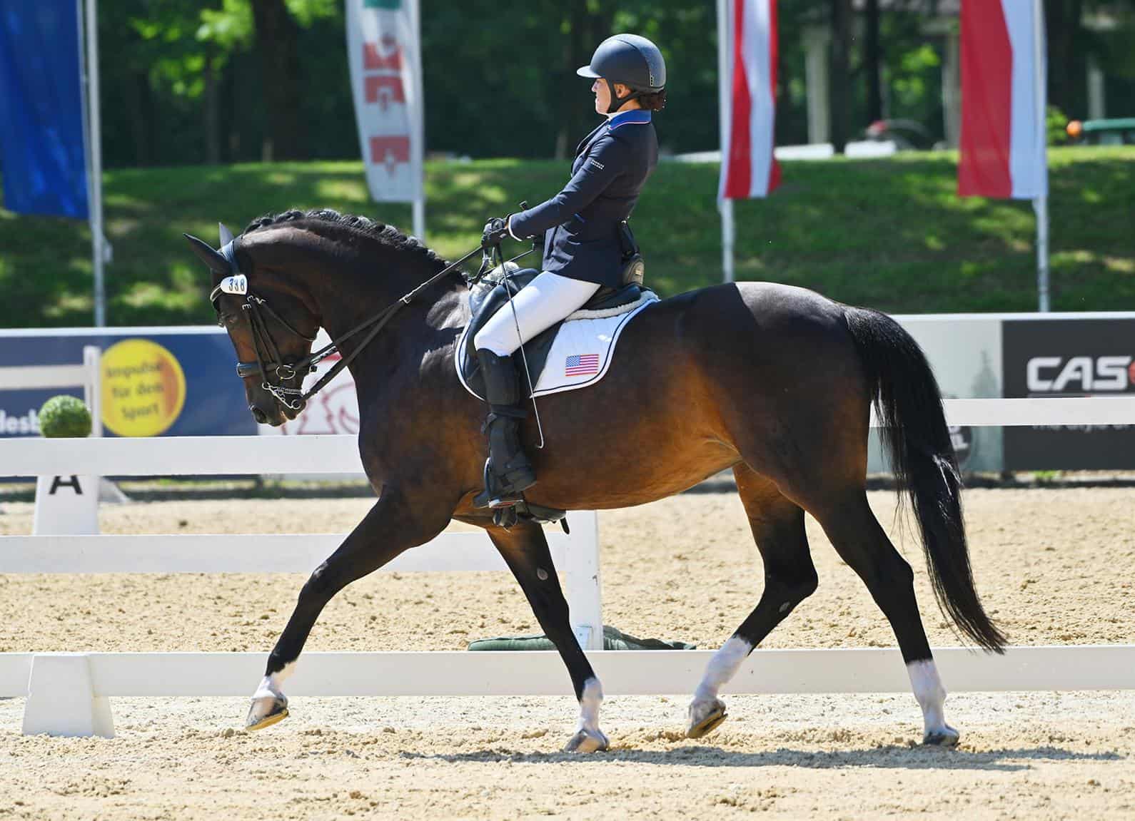 Rebecca Hart and Floratina trotting in the competition arena at Stadl-Paura